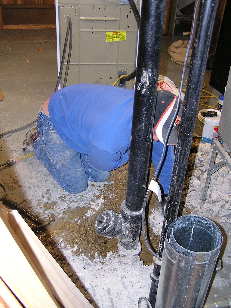 Plumber servicing pipework